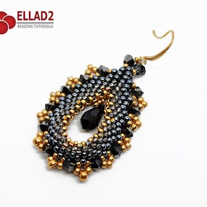 May include: A pair of dangle earrings with a teardrop shape. The earrings are made with black and gold beads and a black crystal.
