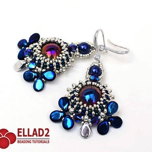 May include: A pair of silver and blue beaded earrings with iridescent glass beads and a silver hook closure. The earrings feature a circular design with a central iridescent glass bead.
