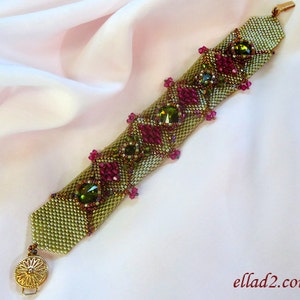 May include: A green and pink beaded bracelet with gold accents and a clasp. The bracelet is made with small seed beads and features larger green and pink beads.
