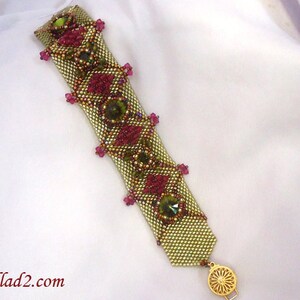 May include: A gold and green beaded bracelet with pink and green accents. The bracelet has a gold clasp.