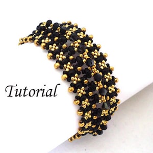 May include: Black and gold beaded bracelet with a geometric pattern. The bracelet is made with small seed beads and has a woven design.