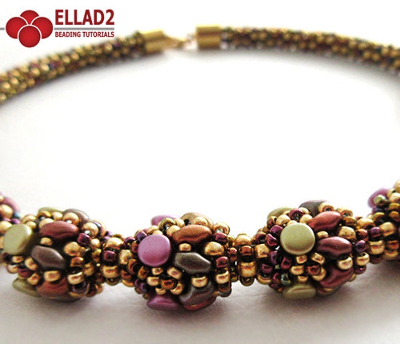 May include: A beaded necklace with three clusters of beads in shades of brown, gold, and purple. The beads are arranged in a flower-like pattern.