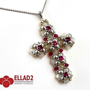 May include: A silver chain necklace with a beaded cross pendant. The cross is made of white and silver beads with red crystal accents. The pendant is approximately 2 inches in length.