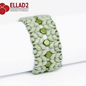 May include: A green and white beaded bracelet with a geometric pattern. The bracelet is made with small, round beads and is designed to be worn on the wrist.