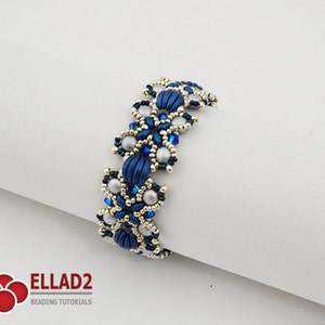 May include: A blue and silver beaded bracelet with a floral design. The bracelet is made with small seed beads and larger round beads.