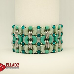 May include: A turquoise and silver beaded bracelet with a geometric pattern. The bracelet is made with round and half-round beads.