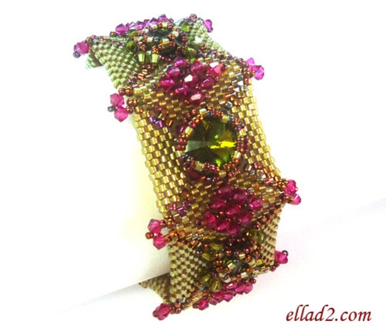 May include: A gold and green beaded bracelet with pink and green crystals. The bracelet is made with a square pattern and has a unique design.