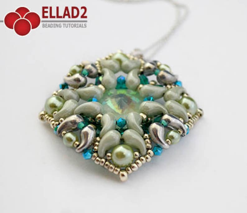 May include: A green and silver beaded pendant with a large iridescent green crystal in the center. The pendant is attached to a silver chain.