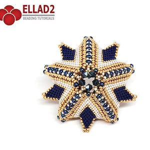 May include: A beaded star ornament with a blue, white, and gold color scheme. The star has a central crystal and is made with seed beads.