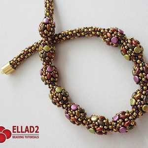 May include: A gold beaded necklace with a series of larger, multi-colored beads. The larger beads are made of smaller beads in shades of brown, green, and purple. The necklace is finished with a gold clasp.