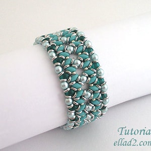 May include: A turquoise and silver beaded bracelet with a geometric pattern. The bracelet is made with small seed beads and is approximately 2 inches wide.