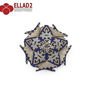 May include: A blue and gold beaded flower with a geometric design. The flower is made with small seed beads and has a starburst pattern in the centre.