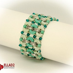 May include: A green and silver beaded bracelet with a geometric pattern. The bracelet is made with small round beads and larger, crescent-shaped beads.