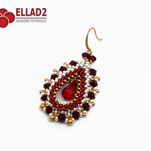 May include: A red and gold beaded teardrop earring with a red crystal in the centre. The earring has a gold hook.