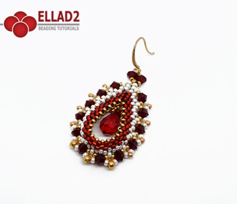 May include: A red and gold beaded teardrop earring with a red crystal in the centre. The earring has a gold hook.