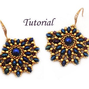 May include: A pair of gold and blue beaded earrings with a starburst design. The earrings are made with small, round beads in shades of gold, blue, and purple. The center of each earring features a larger, round blue bead.