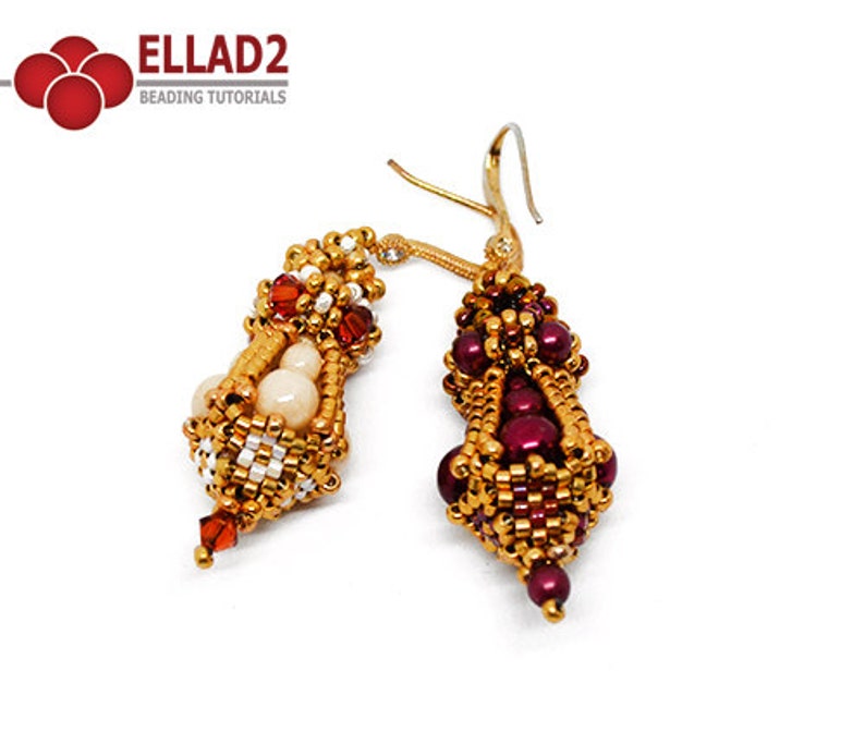 May include: A pair of gold beaded earrings with a teardrop shape. One earring features white and red beads, while the other features burgundy and gold beads. The earrings are made with small seed beads and larger round beads.