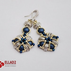 May include: A pair of handmade earrings with a silver and gold design. The earrings feature a square shape with navy blue beads and silver accents. The earrings have a decorative hook and are designed for pierced ears.