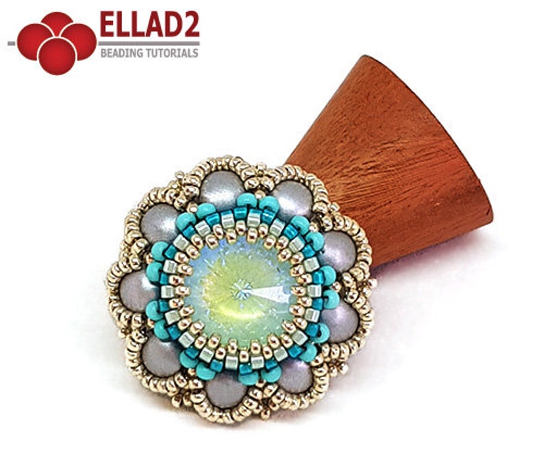 May include: A beaded flower brooch with a turquoise and silver design. The center of the brooch features a large iridescent crystal.