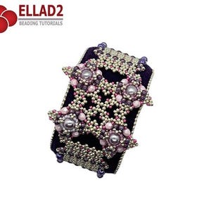 May include: A beaded bracelet with a purple velvet base and silver, pink, and purple beads. The beads are arranged in a geometric pattern, forming a star shape.
