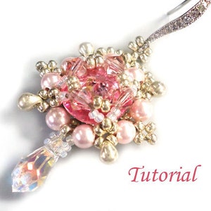 May include: Pink and gold beaded earring with a crystal drop. The earring features a pink and gold beaded flower design with a crystal center. The earring is attached to a silver wire.