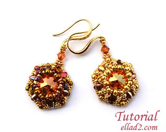 May include: A pair of gold earrings with a beaded design and a large, faceted, amber-colored crystal in the center of each earring.