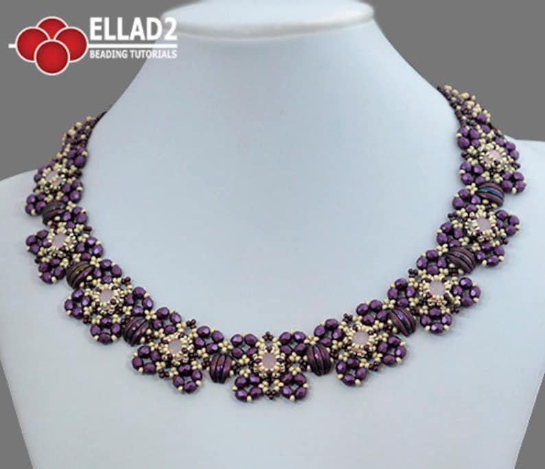 May include: A purple and gold beaded necklace with a floral design. The necklace is made with small, round beads and features a central motif of a flower.