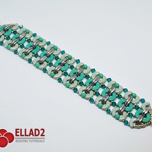May include: A turquoise and white beaded bracelet with silver accents. The bracelet is made with small, round beads and has a clasp closure.