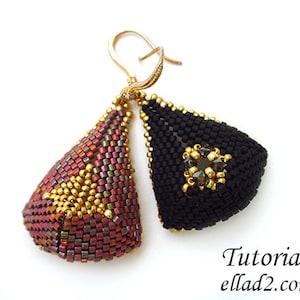 May include: A pair of handmade earrings with a geometric design. One earring is black with gold accents and the other is a mix of gold, red, and purple.