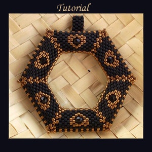 May include: A black and gold beaded pendant with a hexagonal shape and a central opening. The pendant is decorated with small black beads and gold beads arranged in a geometric pattern.