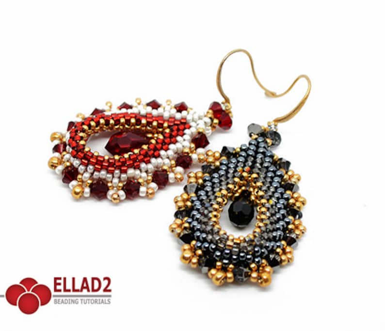 May include: A pair of beaded earrings in a teardrop shape. One earring is red, white, and gold, and the other is black, grey, and gold. Both earrings have a crystal bead in the centre.