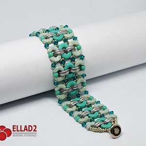 May include: A turquoise and silver beaded bracelet with a magnetic clasp. The bracelet is made with a variety of beads, including round, oval, and crescent-shaped beads.