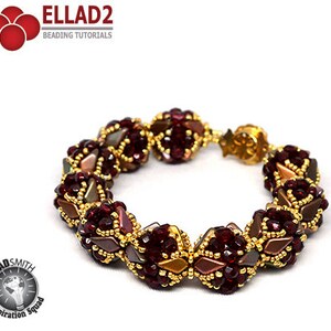 May include: A burgundy and gold beaded bracelet with a clasp closure. The bracelet is made with small, faceted beads and has a geometric design.