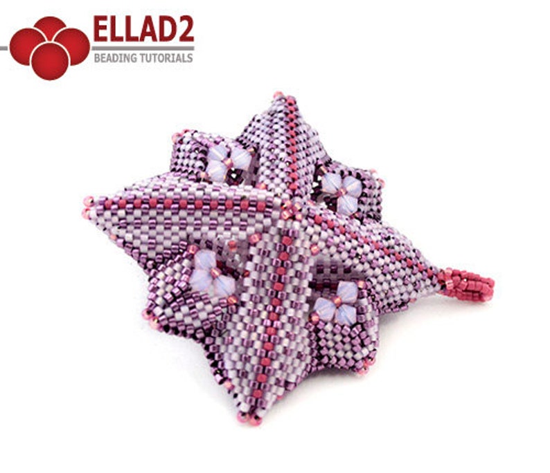 Pode incluir: Uma flor de contas rosa e branca com um design em forma de estrela. A flor &eacute; feita com contas pequenas e tem um padr&atilde;o delicado e intrincado.