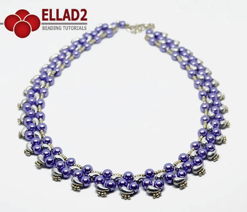 May include: A beaded necklace featuring a combination of purple and silver beads. The necklace has a layered design with a delicate chain clasp. The beads are arranged in a symmetrical pattern, creating a stylish accessory. The necklace is suitable for various occasions.