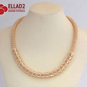 May include: A delicate, cream-colored beaded necklace with gold accents. The necklace is made of small, round beads and is arranged in a simple, elegant design. The necklace is displayed on a white mannequin.