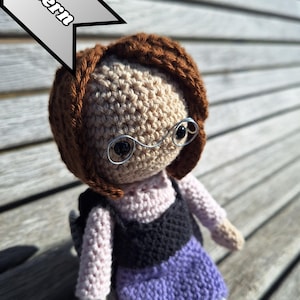 May include: A white ceramic mug with a black handle and the text "But First, Coffee" in a bold, black font. The mug is displayed on a white surface.