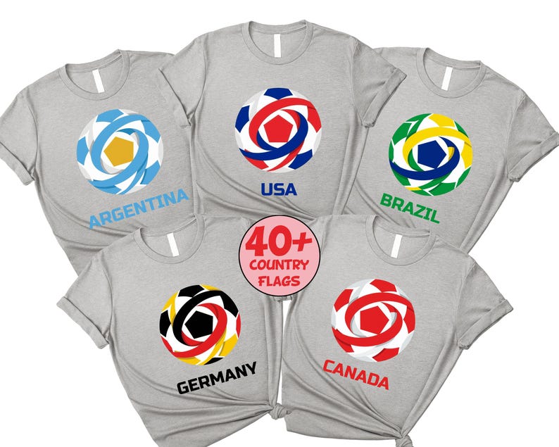 May include: A collection of light gray t-shirts featuring soccer ball designs with country flags. The shirts display flags of Argentina, USA, Brazil, Germany, and Canada. A circular graphic states "40+ COUNTRY FLAGS".
