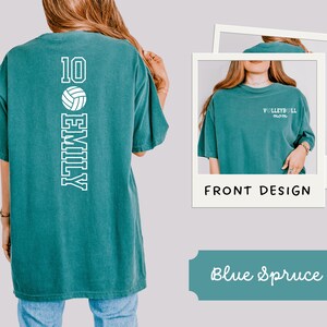 May include: Teal blue t-shirt with white text and a volleyball graphic. The back of the shirt features the number 10, a volleyball, and the name "EMILY". The front of the shirt says "Volleyball mom".