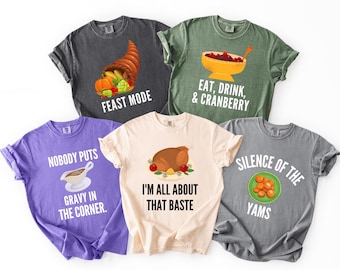May include: Five t-shirts with Thanksgiving-themed graphics and text. Designs include a cornucopia, a bowl of cranberry sauce, a roasted turkey, a plate of yams, and a gravy boat. Text includes "Feast Mode," "Eat, Drink, & Cranberry," "Nobody Puts Gravy in the Corner," "I'm All About That Baste," and "Silence of the Yams."