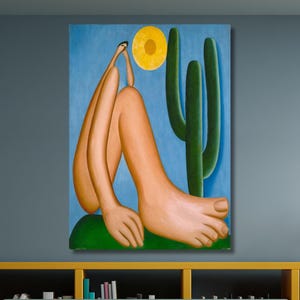 May include: A colorful painting depicts a figure with elongated limbs, seated near a cactus under a yellow sun. The artwork features a blue sky background and a green base. The painting is displayed above a green sofa and yellow shelving unit.