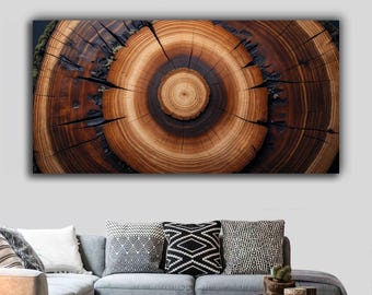 May include: A rectangular canvas print featuring a detailed cross-section of a tree trunk. The artwork showcases concentric rings in shades of brown and tan, with dark cracks and a central core. The print is displayed above a gray sofa with decorative pillows.