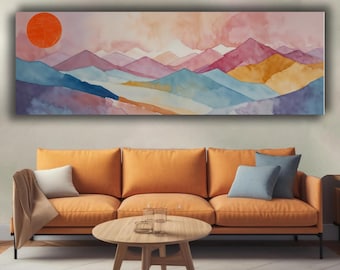 Può includere: Un dipinto ad acquerello di un paesaggio montano con un grande sole arancione. Le montagne sono dipinte in tonalità di blu, viola, rosa e giallo. L'opera d'arte è esposta sopra un divano arancione con un tavolino di legno.