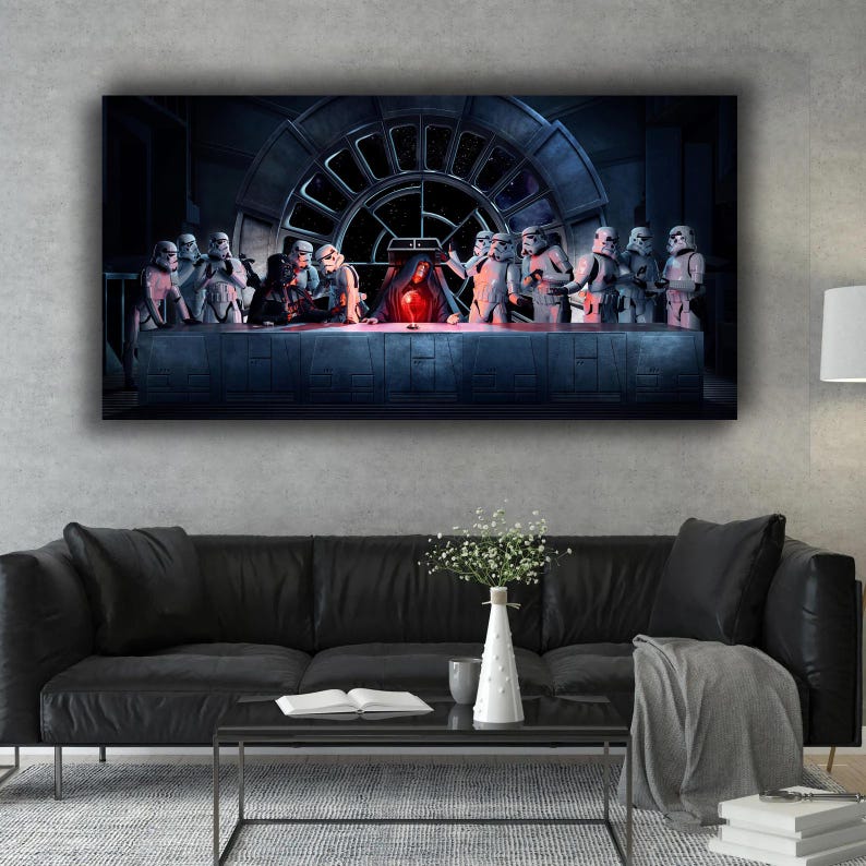 May include: A framed canvas print depicting a parody of The Last Supper, featuring Star Wars characters. Stormtroopers and Darth Vader are seated at a table with a Millennium Falcon window in the background. The artwork is displayed above a black sofa.