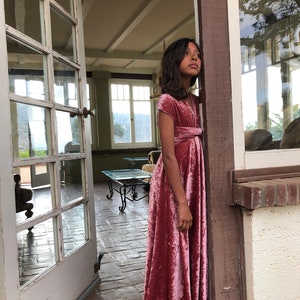 Girl in crushed Velvet Peony floor length gown. staring off through french doors not the Island of Catalina.