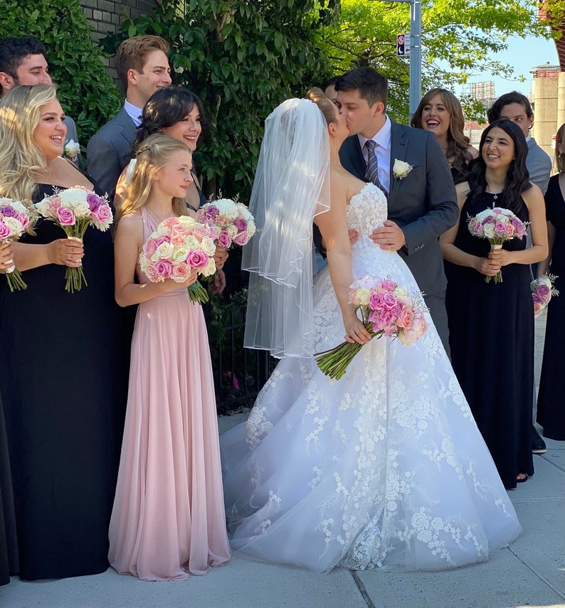 Daughter of the bride, flower girl in blush sheer chiffon tulle infinity dress with groom kissing bride