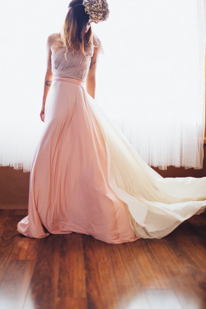 Whimsical Woman with Ivory layered detachable sash train in room in font of curtains