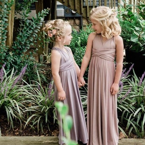 Girl's smileing at each other in Garden in Mauve, dusty lavender long Infinity gown.