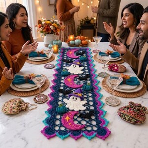 Peut inclure: Un chemin de table en crochet rectangulaire avec un motif en treillis bleu foncé et des bords festonnés rose vif et bleu sarcelle. Il est orné de fantômes blancs au crochet portant des chapeaux de sorcière violets, des lunes roses et des chauves-souris noires.