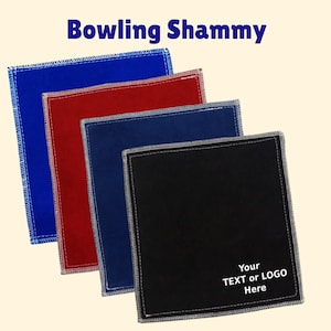 May include: Four different colored microfiber cloths with stitched edges. The cloths are blue, red, dark blue, and black. The black cloth has the text "Your TEXT or LOGO Here" printed on it.